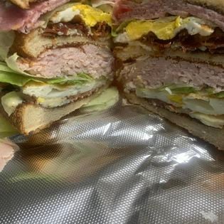 Stacked deli club sandwich cut in half